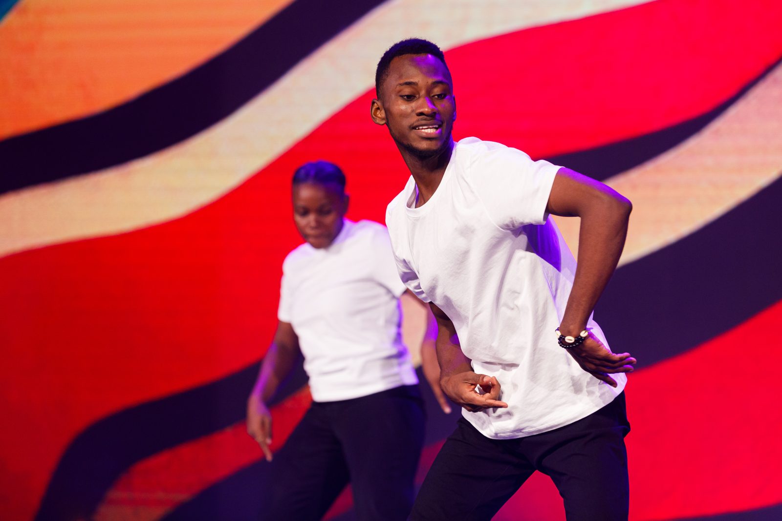 Students performing an African dance on stage