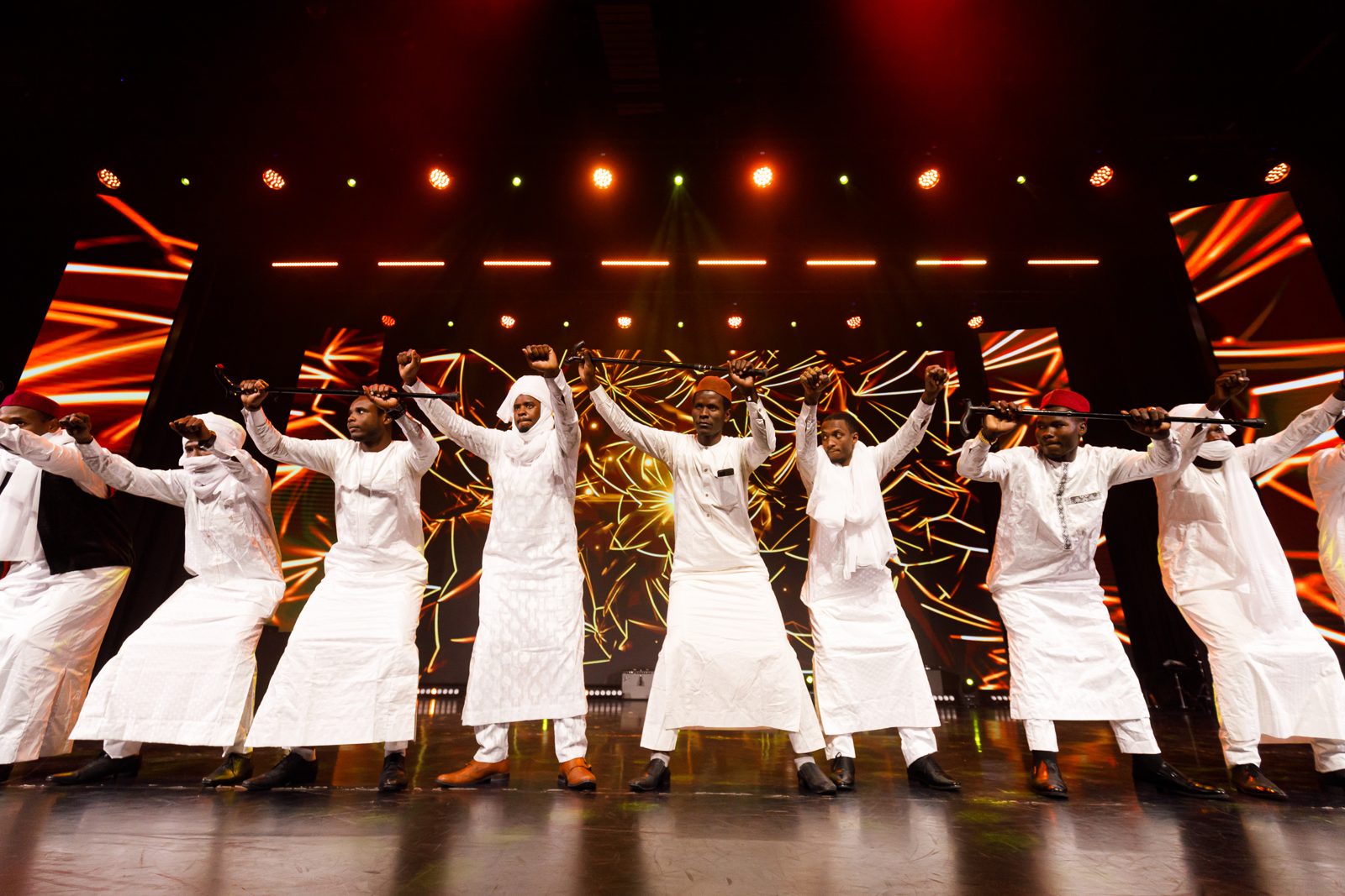 A group dance performance in traditional white dress