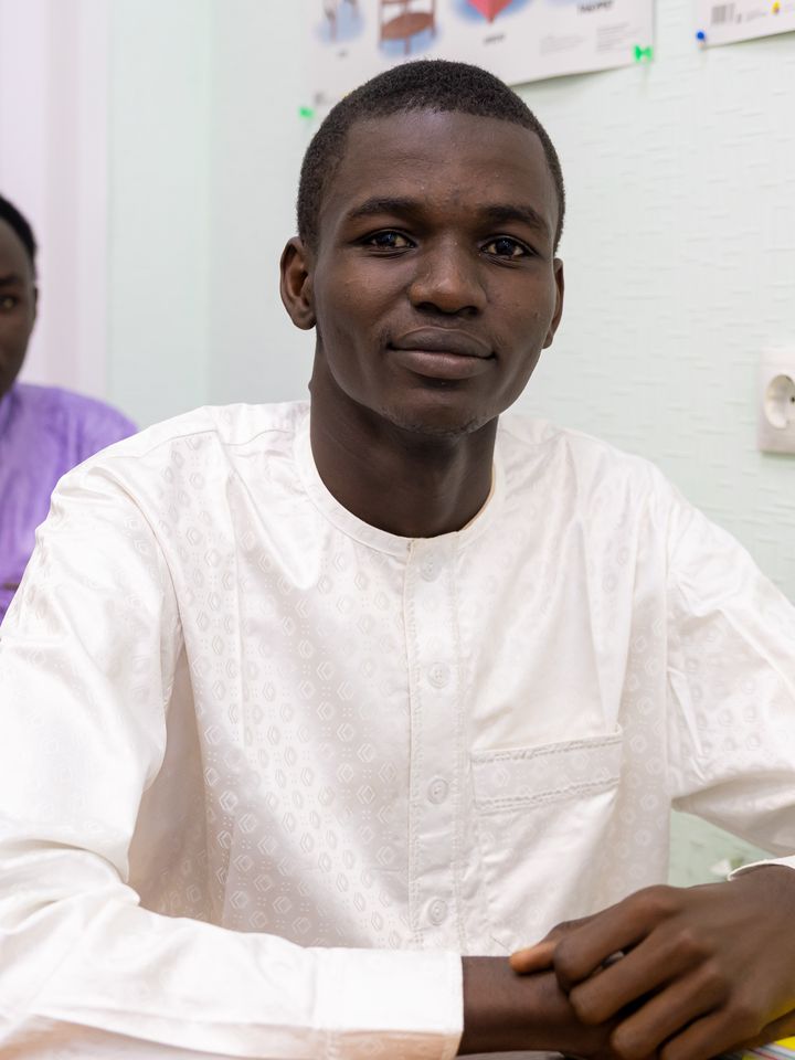 A smiling international student in class