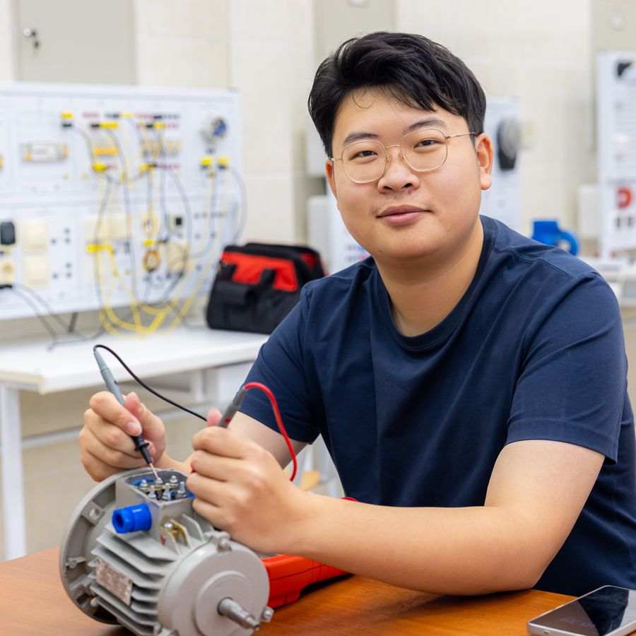 A student working with an electric motor in a lab