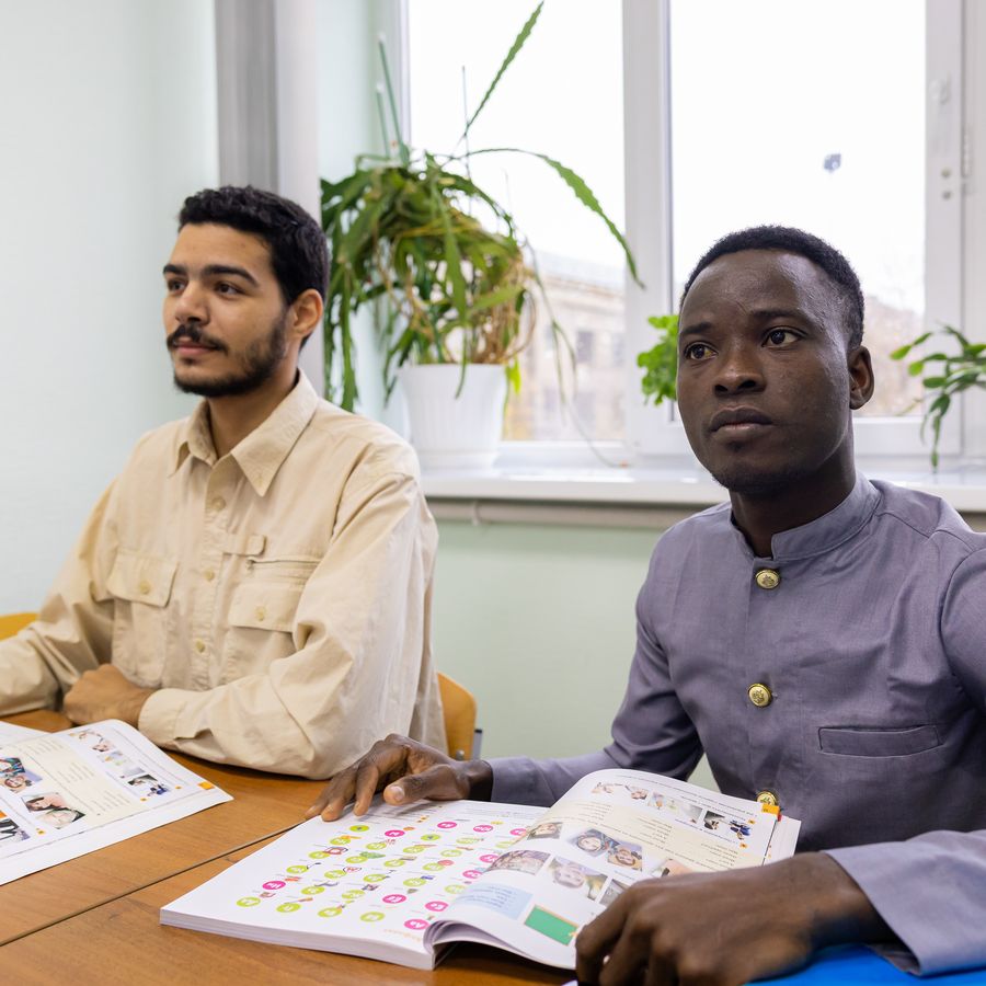 Two students studying with a textbook