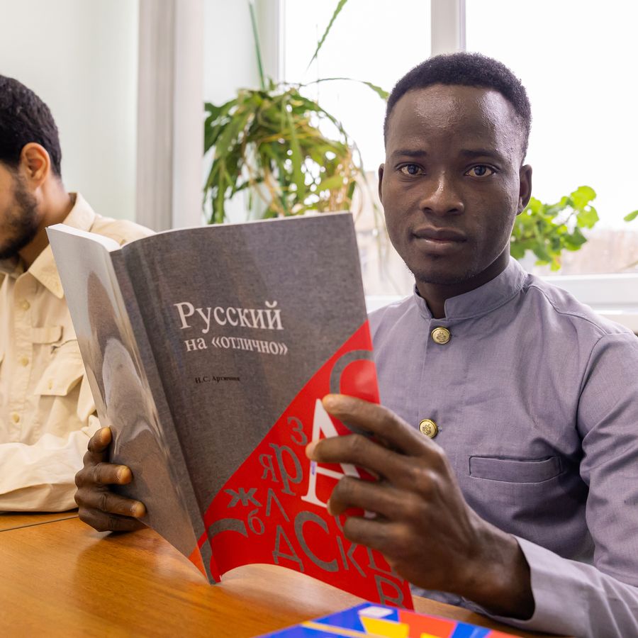 A student reading a Russian textbook