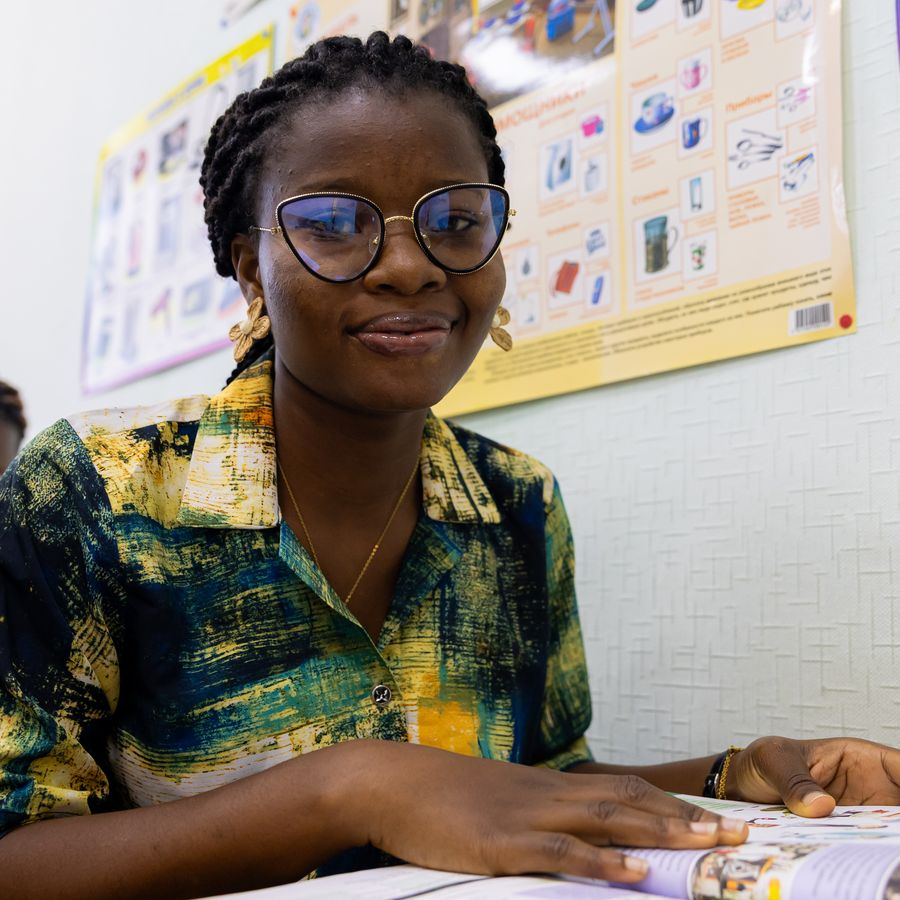 A smiling student in a Russian language class