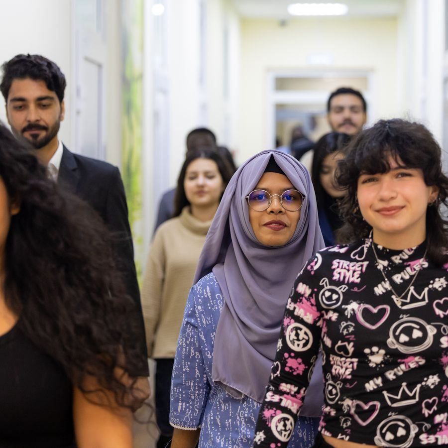 Students chatting in a corridor between classes