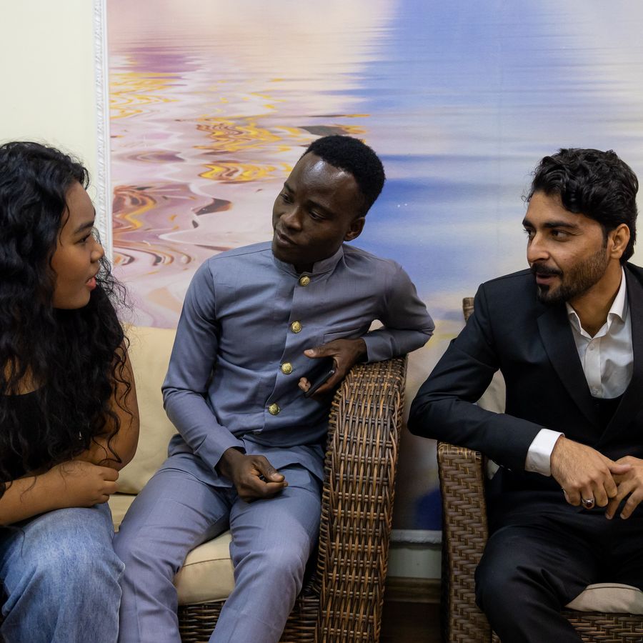 Students relaxing on a sofa in a common room
