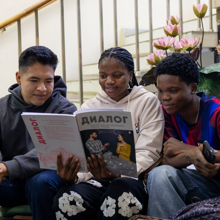 Friends reading a Russian magazine together