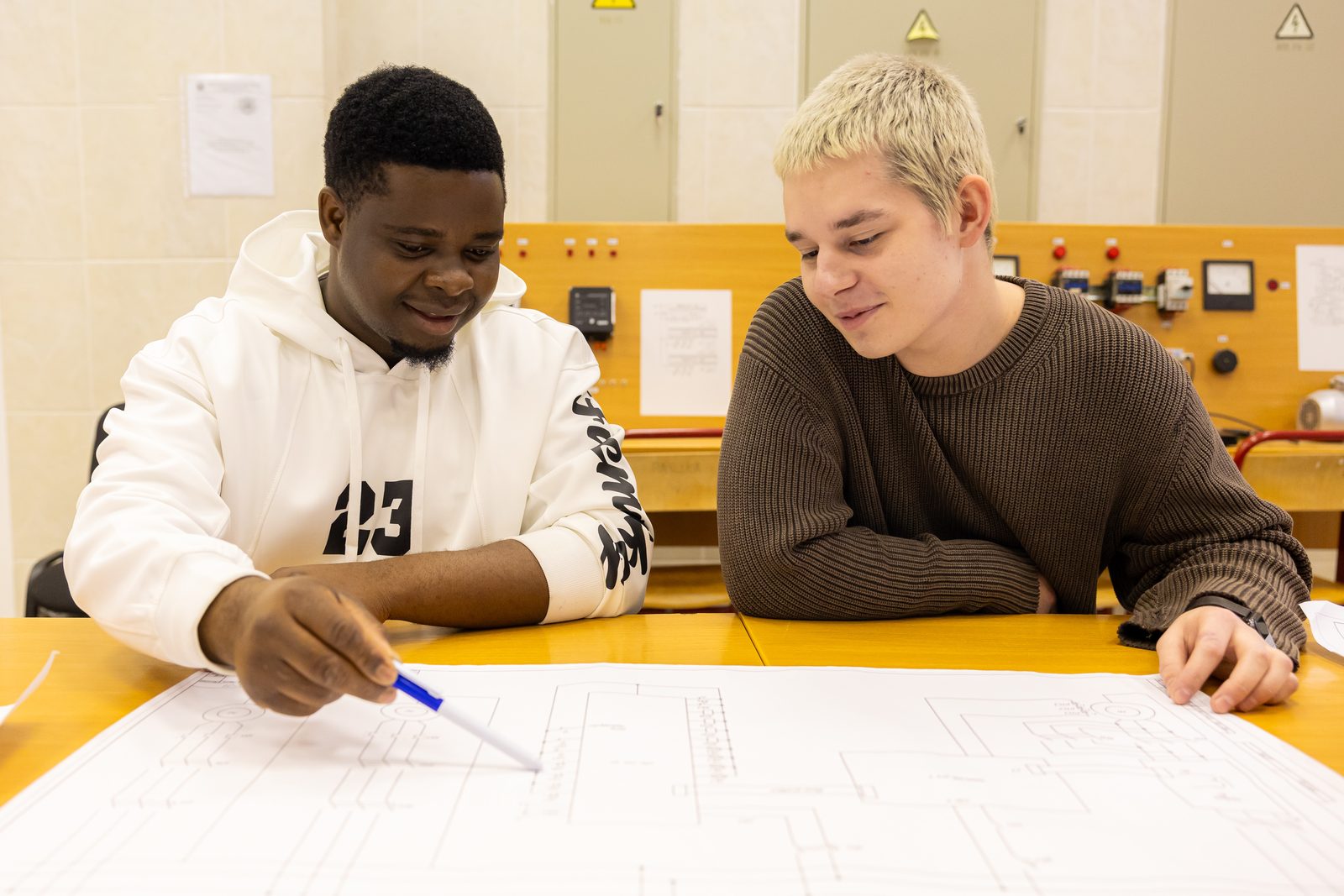 International and Russian students working together on an engineering drawing